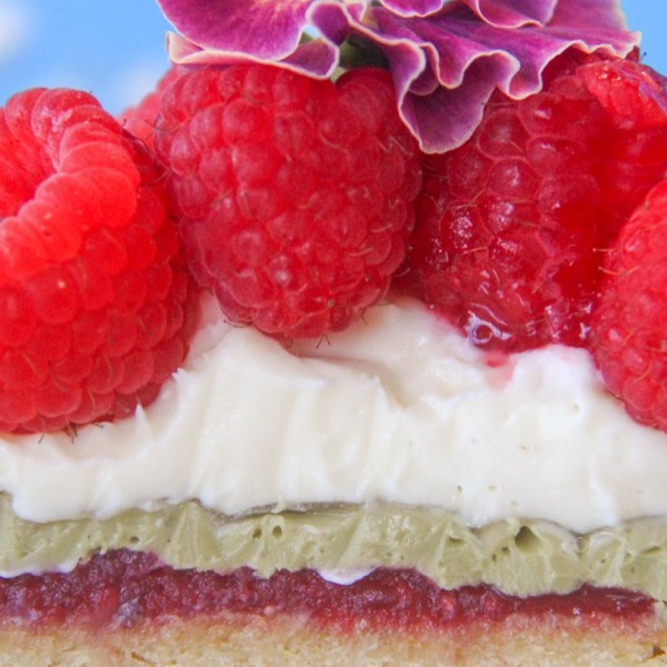 A raspberry and pistachio petal tart, cut open